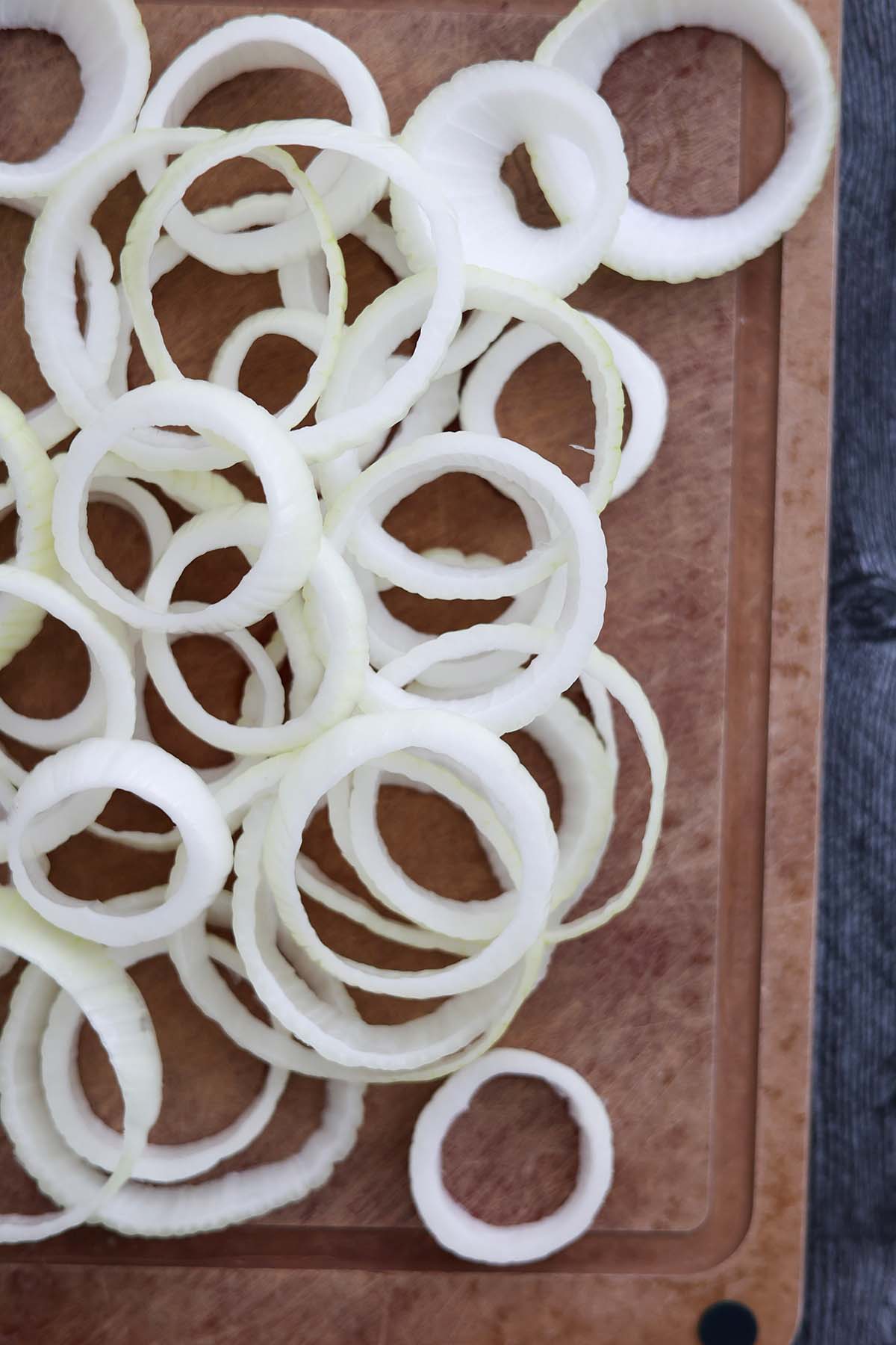 sliced onion rings on a cutting board. 