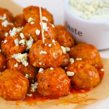 honey buffalo chicken meatballs with blue cheese crumbles on top.