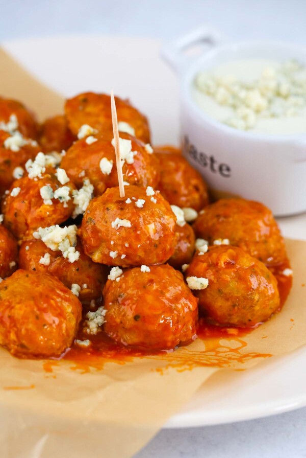 honey buffalo chicken meatballs with blue cheese crumbles on top.