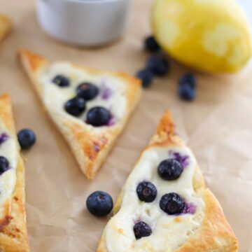 baked lemon blueberry danish on parchment paper.