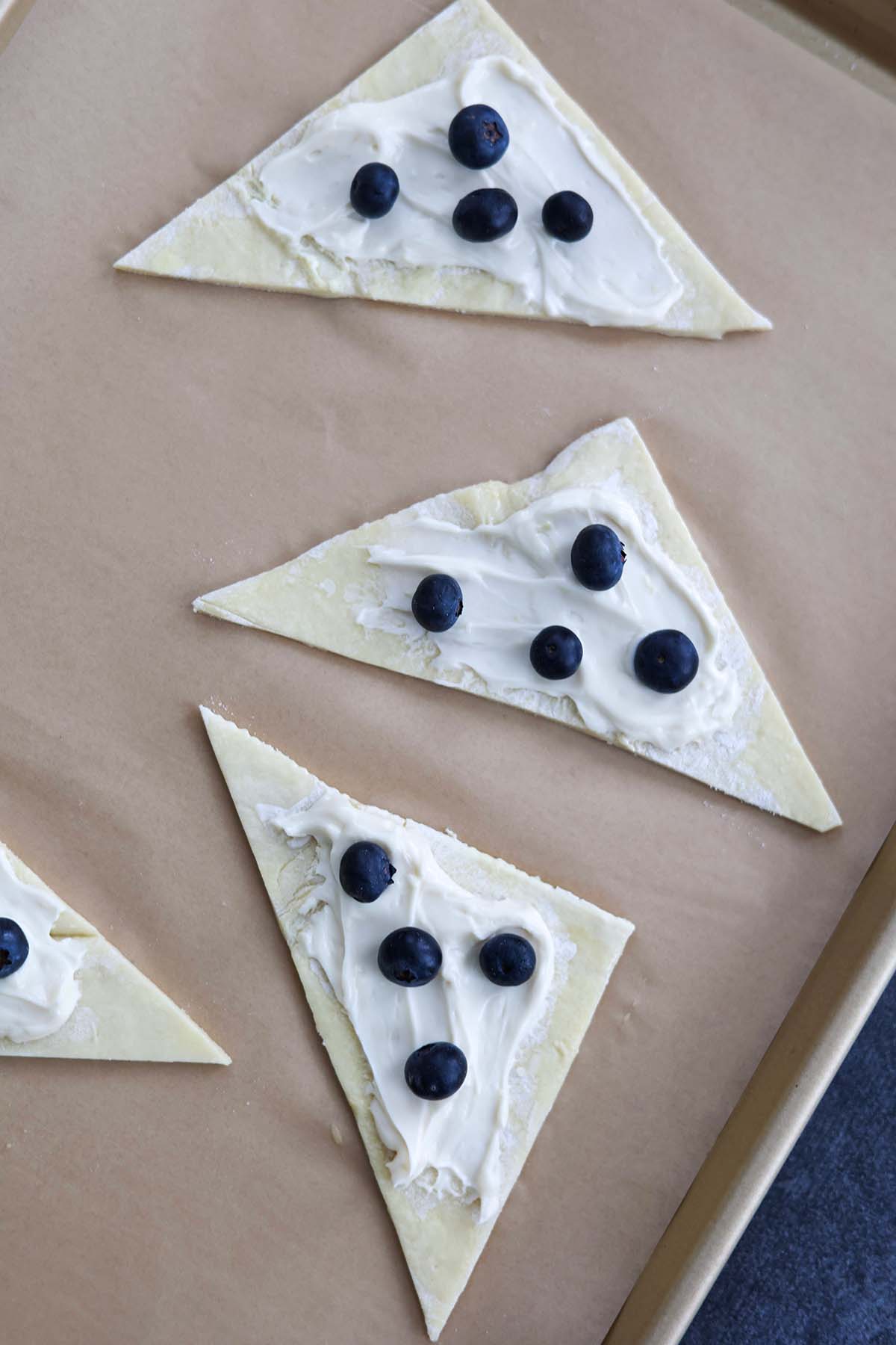 puff pastry triangles with cream cheese and blueberries. 