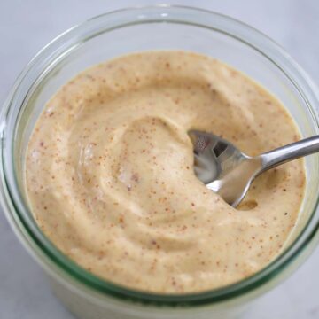 spicy aioli in a jar with a spoon.