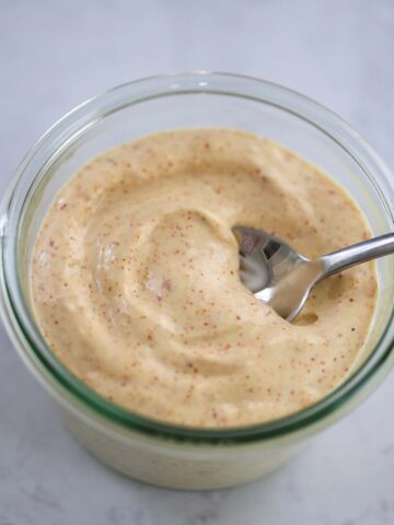 spicy aioli in a jar with a spoon.
