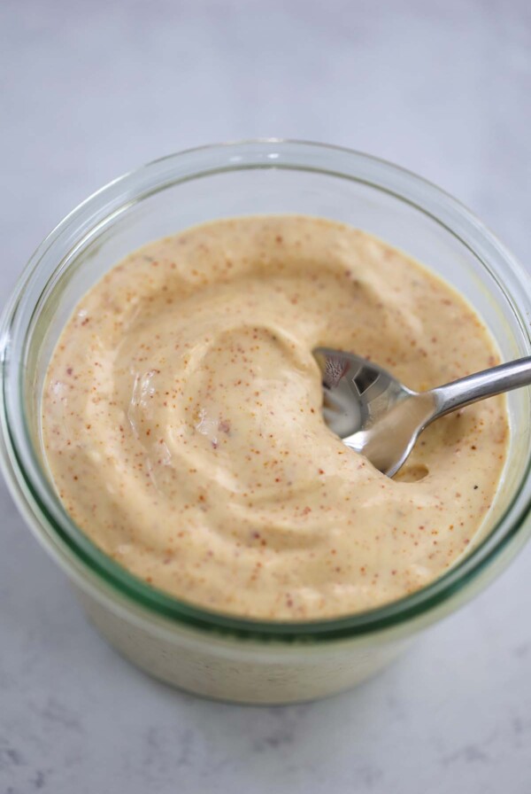 spicy aioli in a jar with a spoon.