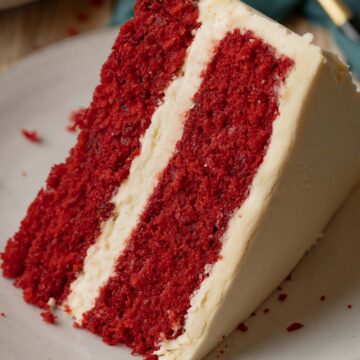 Southern red velvet 2-layer cake slice on a plate.