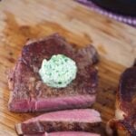 garlic herb compound butter on sliced steak.