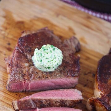 garlic herb compound butter on sliced steak.