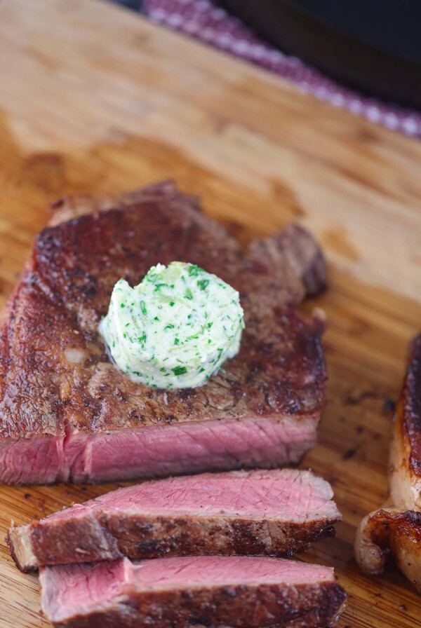 garlic herb compound butter on sliced steak.