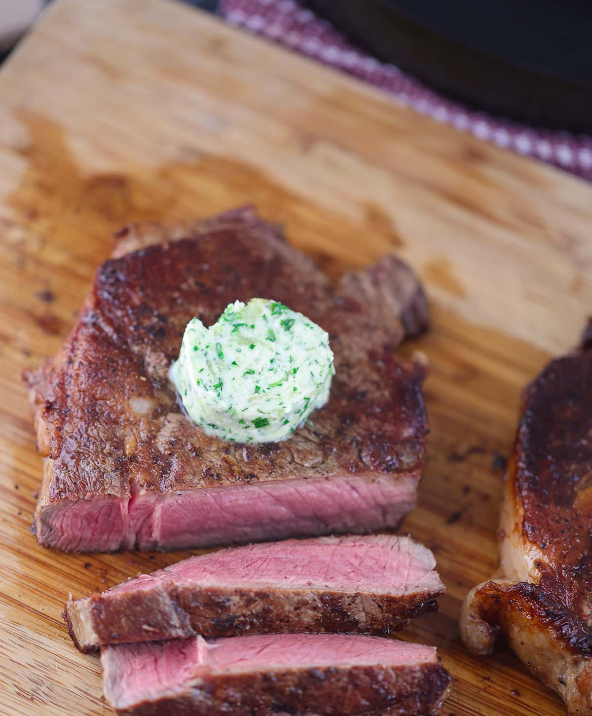 garlic herb compound butter on sliced steak. 