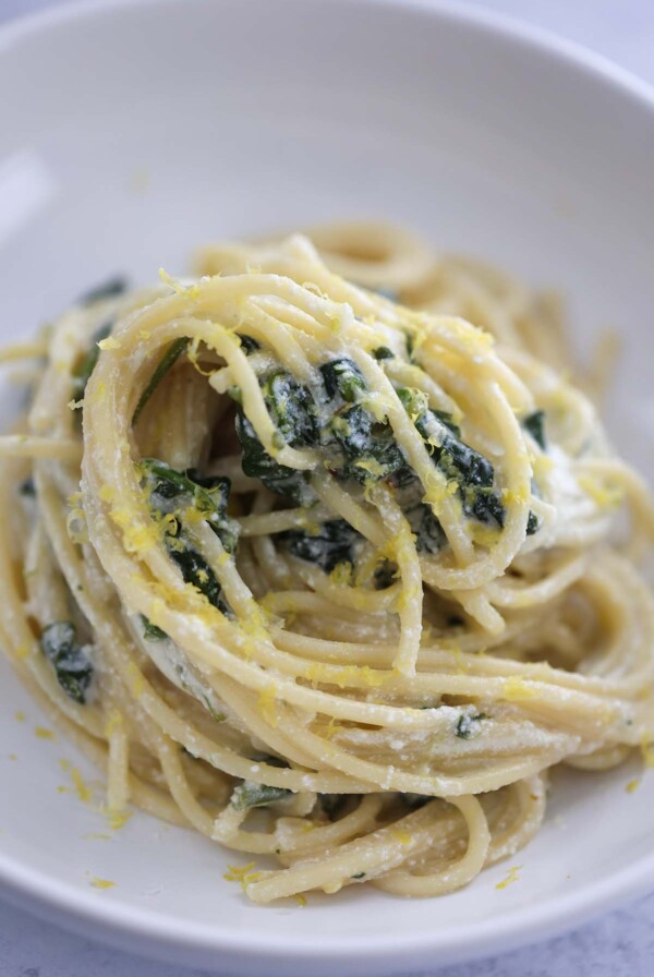 lemon ricotta pasta in a white dish up close.