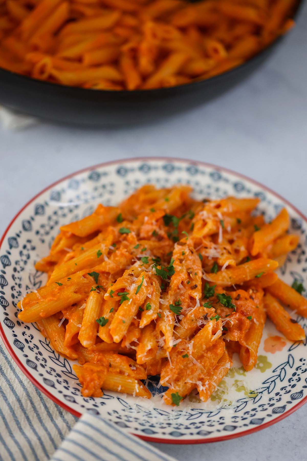 penne alla vodka with parmesan cheese and parsley on top.