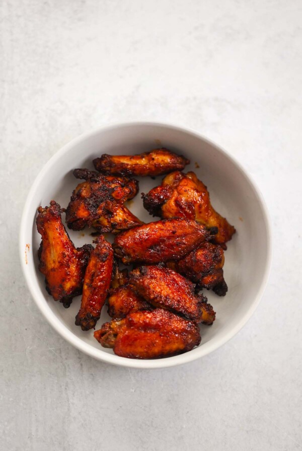 air fryer honey bbq wings on a white plate.