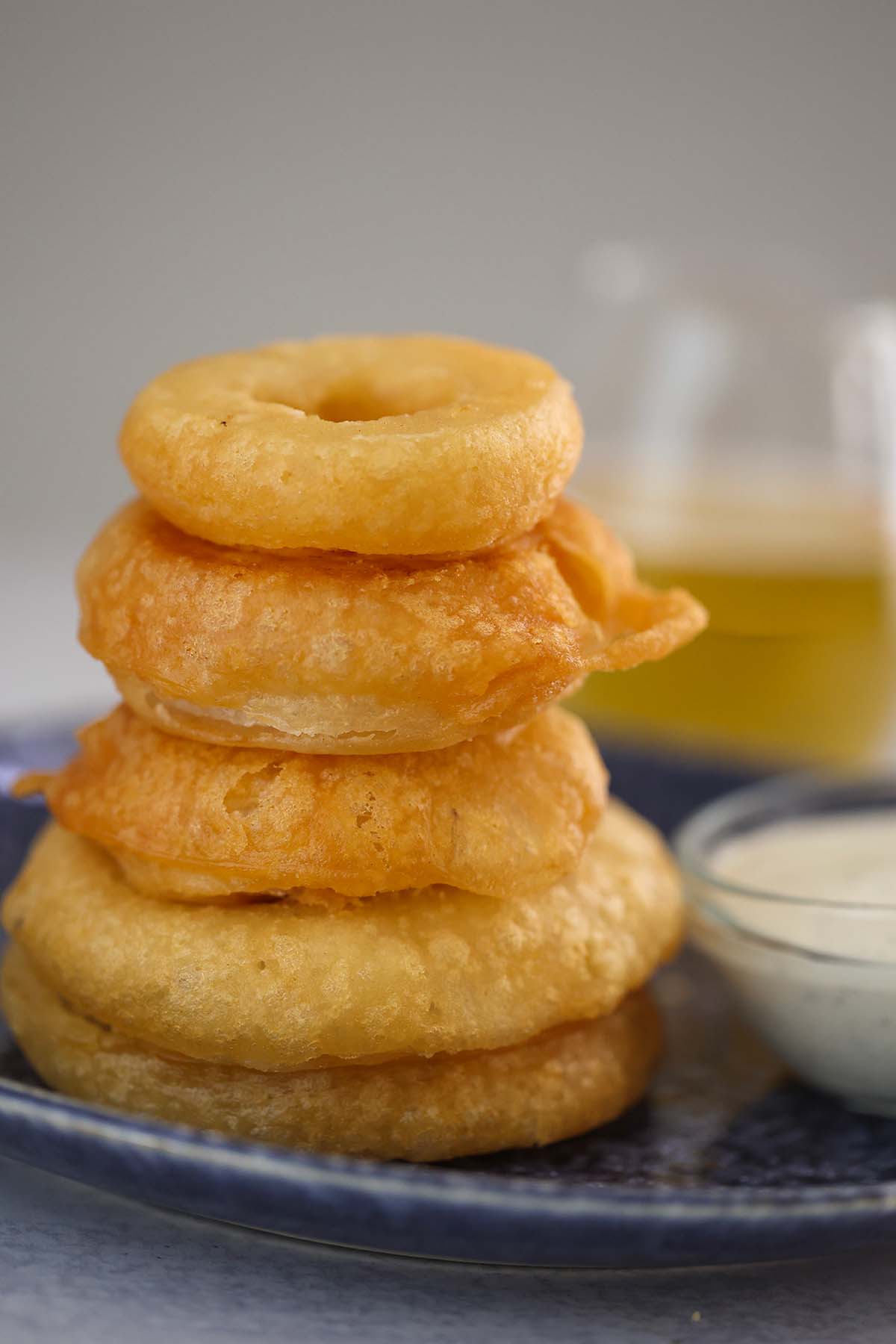 five stacked onion rings on a plate. 