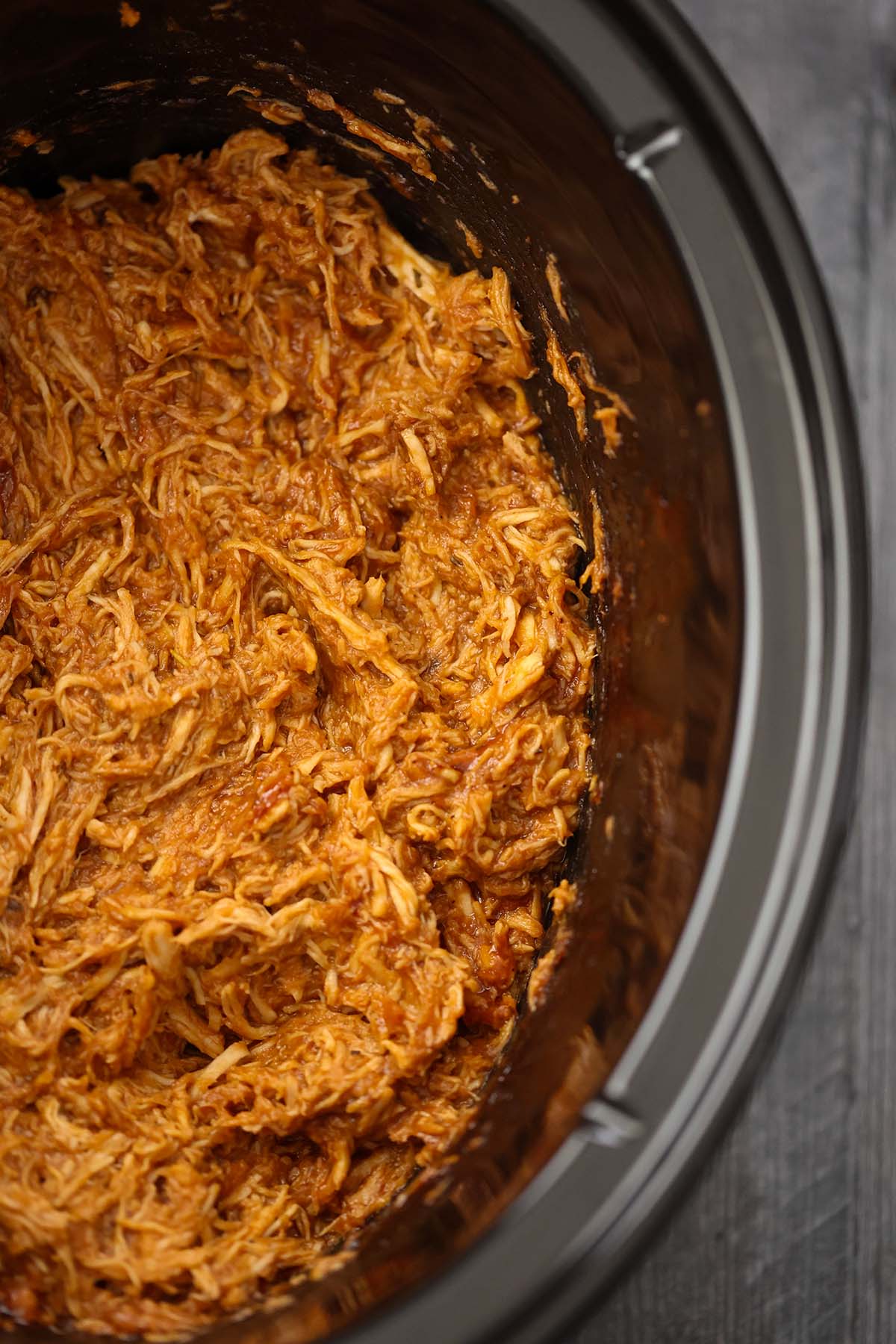 Shredded bbq chicken in the slow cooker up close. 