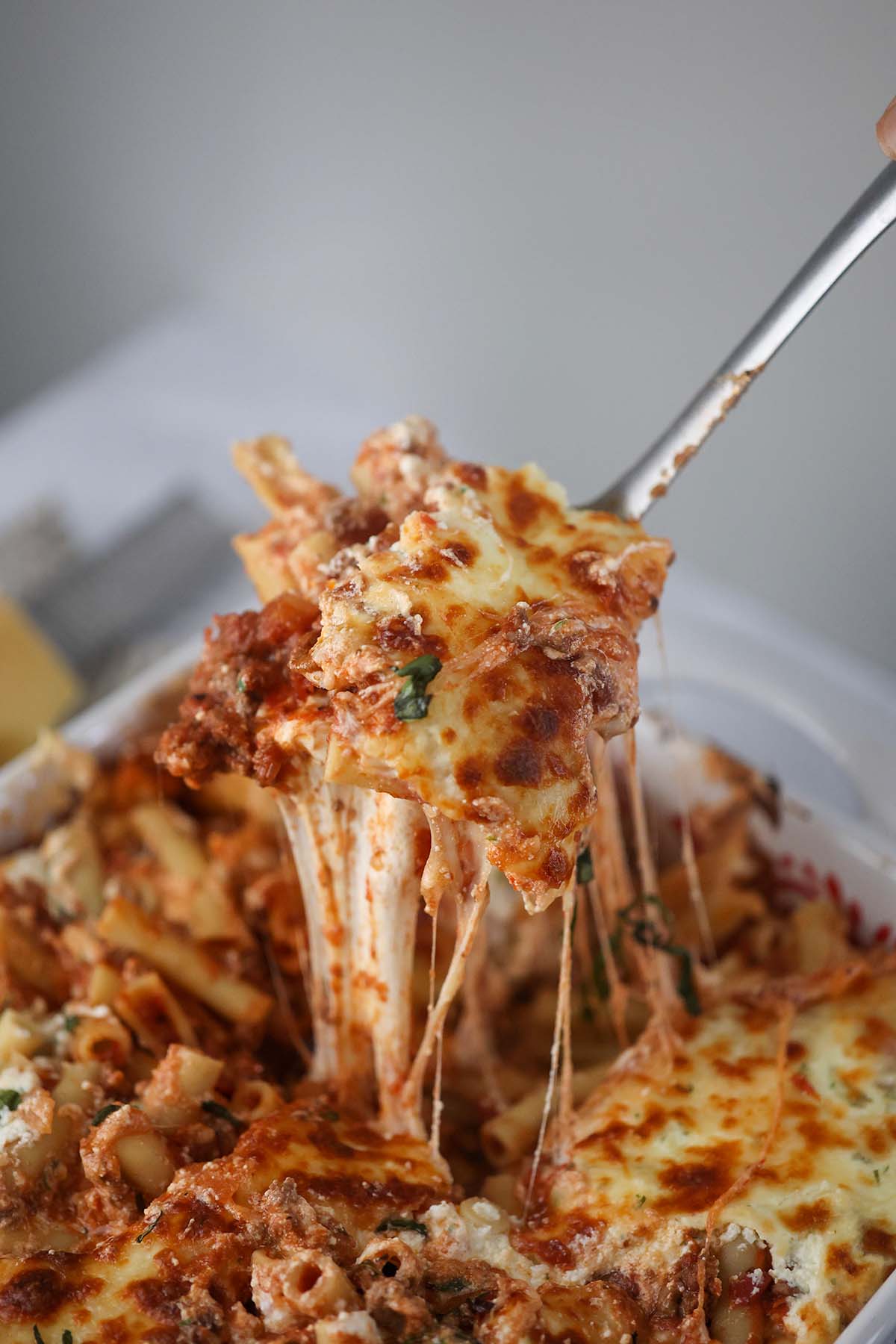 a spoonful of baked ziti with lots of cheese. 