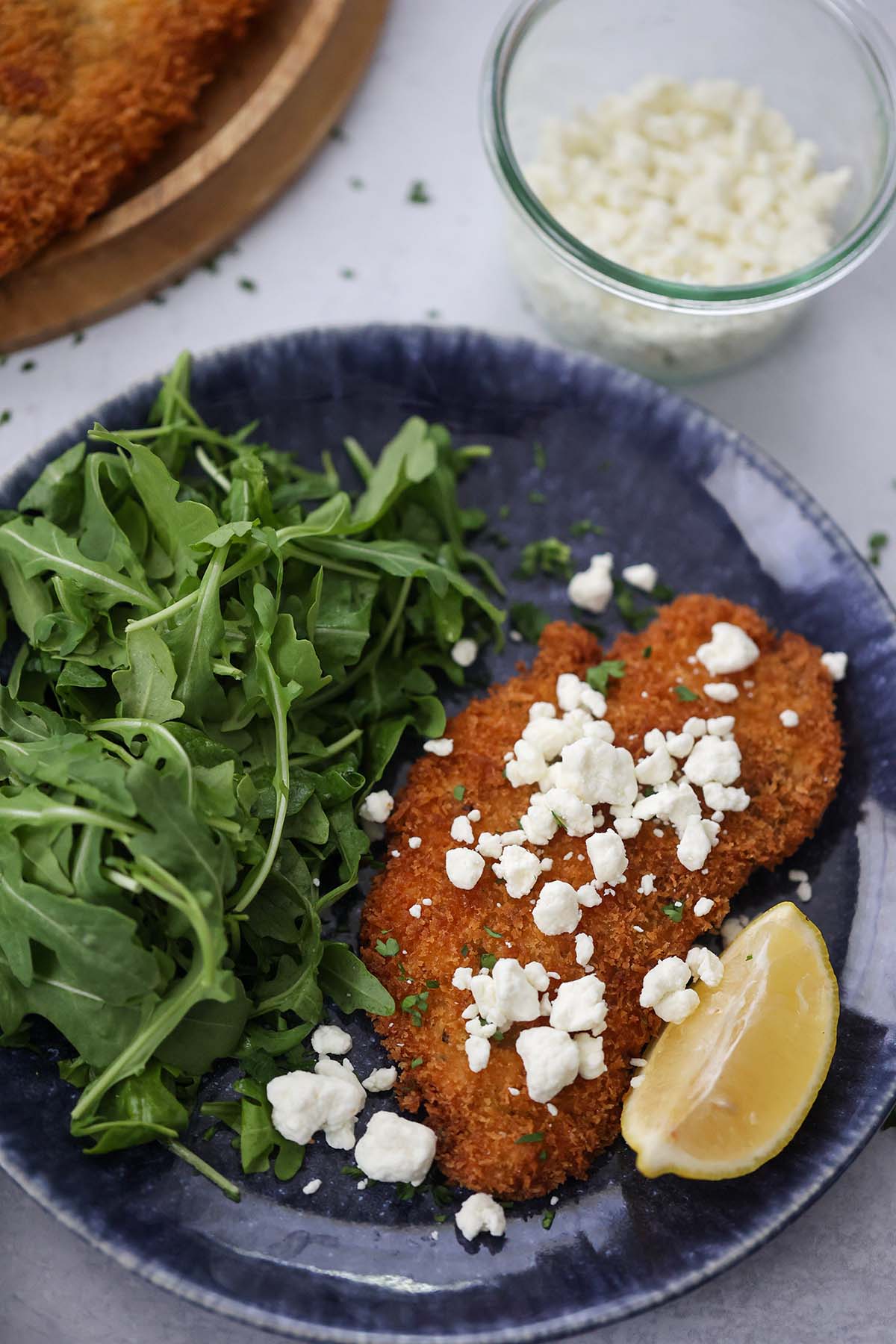 crispy chicken Milanese with goat cheese crumbles on top. 