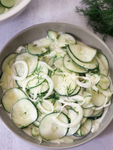 creamy cucumber salad in a bowl.