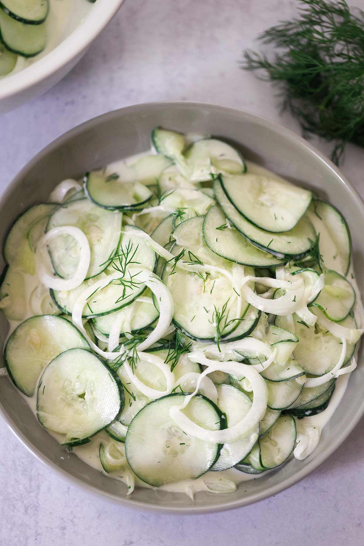 creamy cucumber salad in a bowl. 