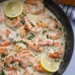 creamy shrimp piccata in a skillet with bread on the side.