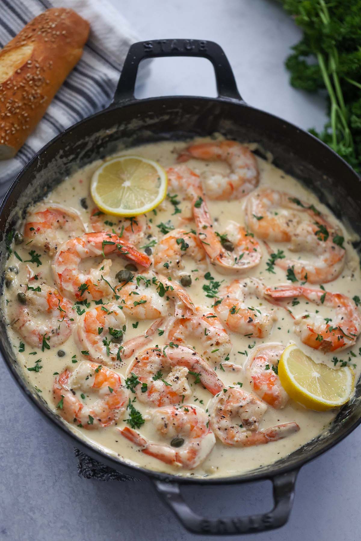creamy shrimp with bread and parsley on the side. 