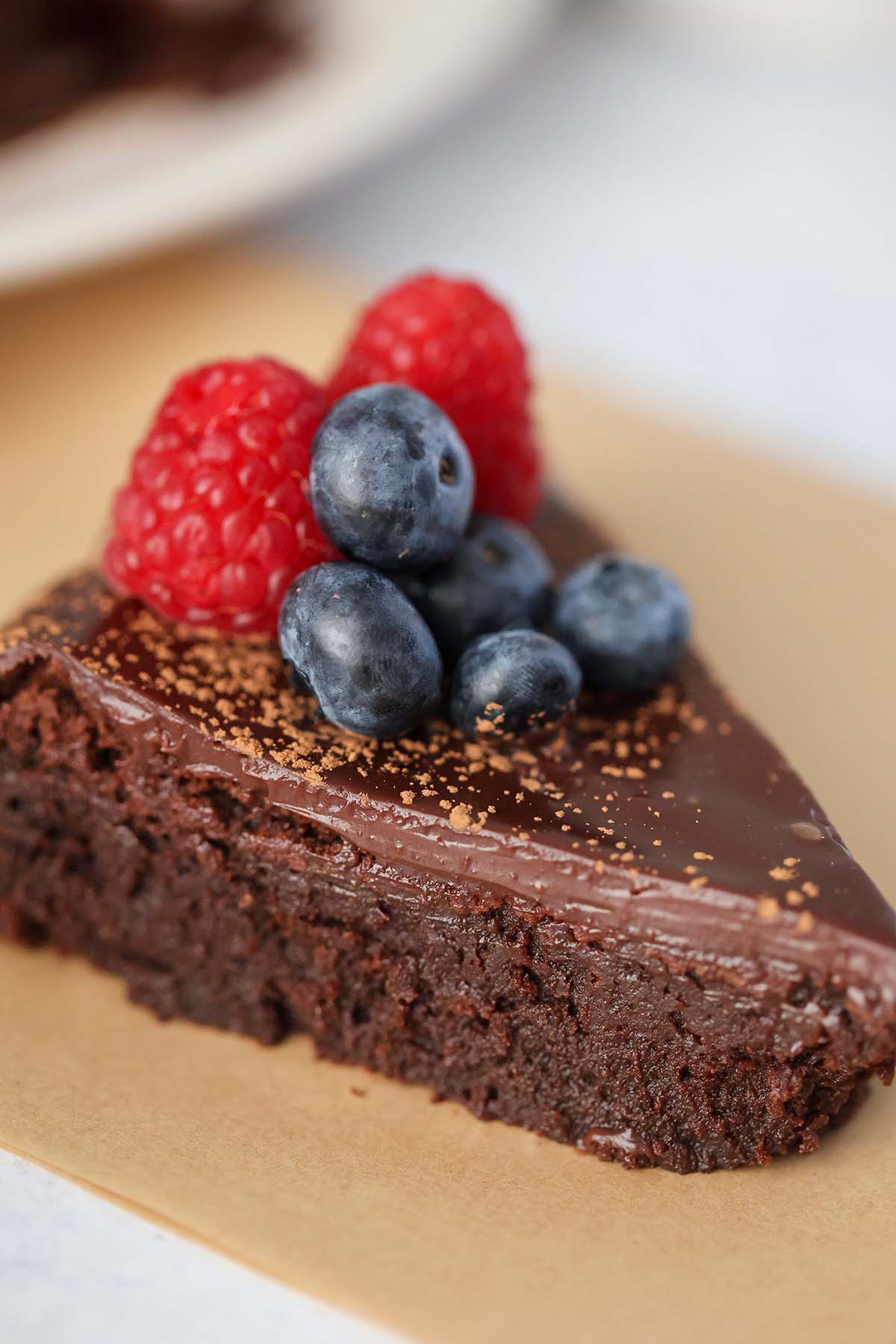 slice of flourless chocolate cake with berries on top. 