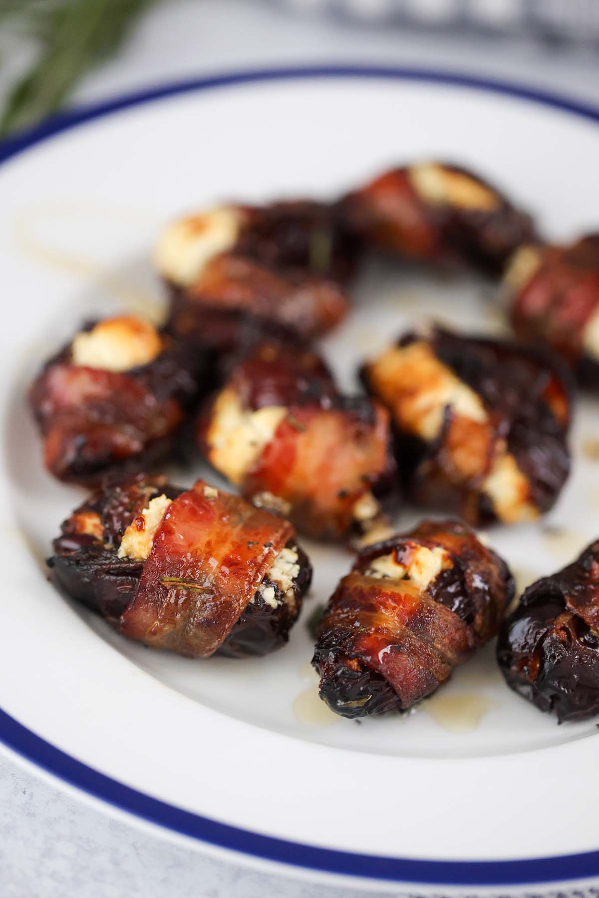 goat cheese bacon wrapped dates on a plate. 