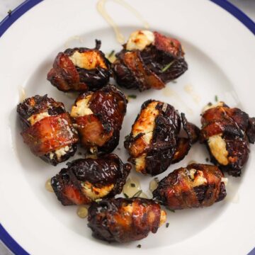air fryer goat cheese bacon wrapped dates on a plate.