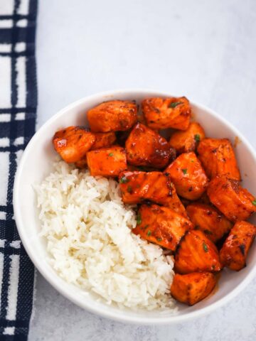 hot honey salmon bites with white rice on the side.