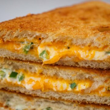 three jalapeno popper grilled cheese sandwiches up close.