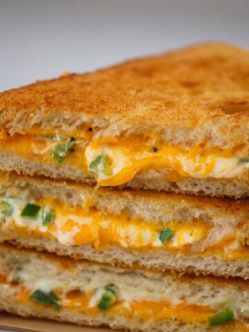three jalapeno popper grilled cheese sandwiches up close.