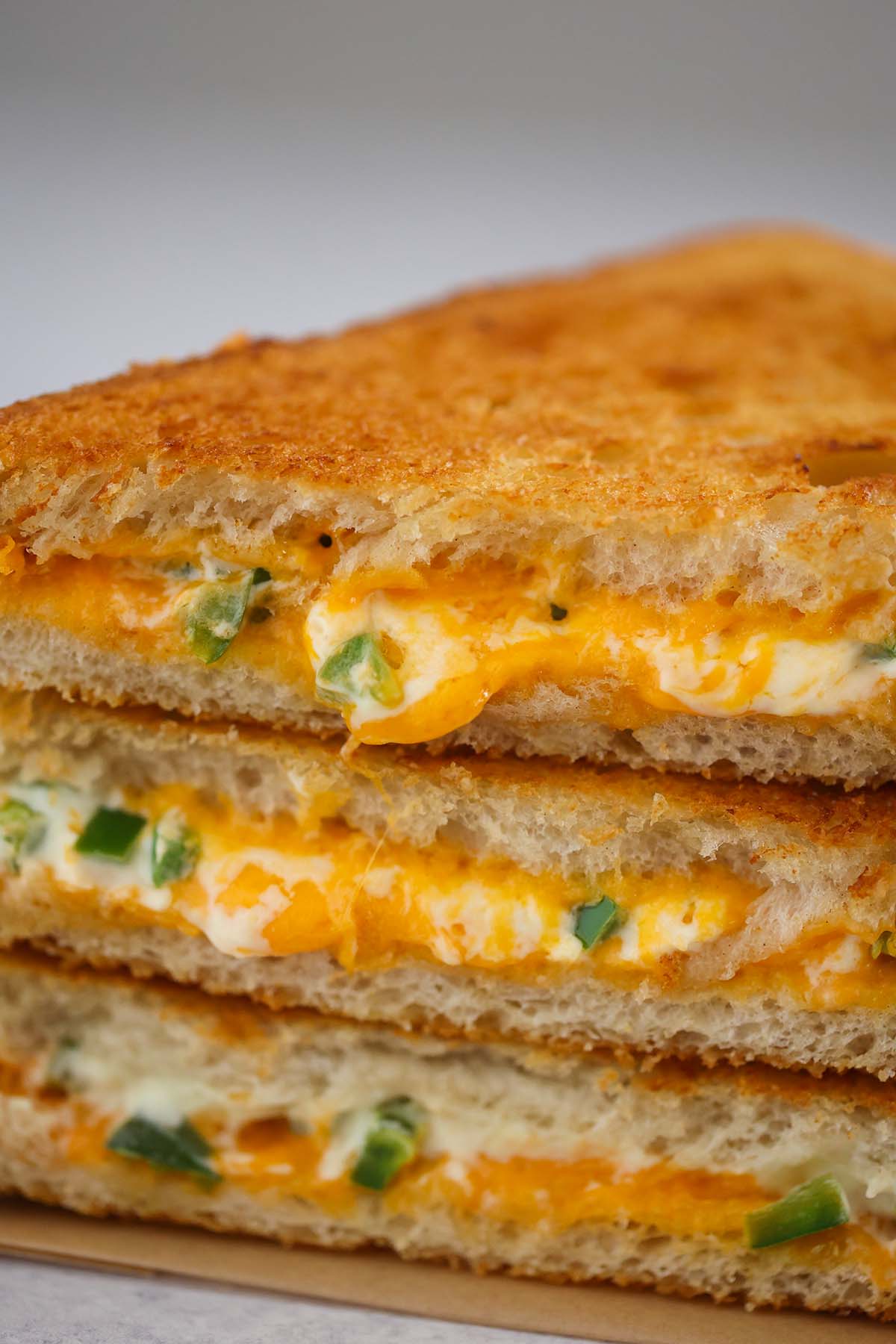 three jalapeno popper grilled cheese sandwiches up close. 