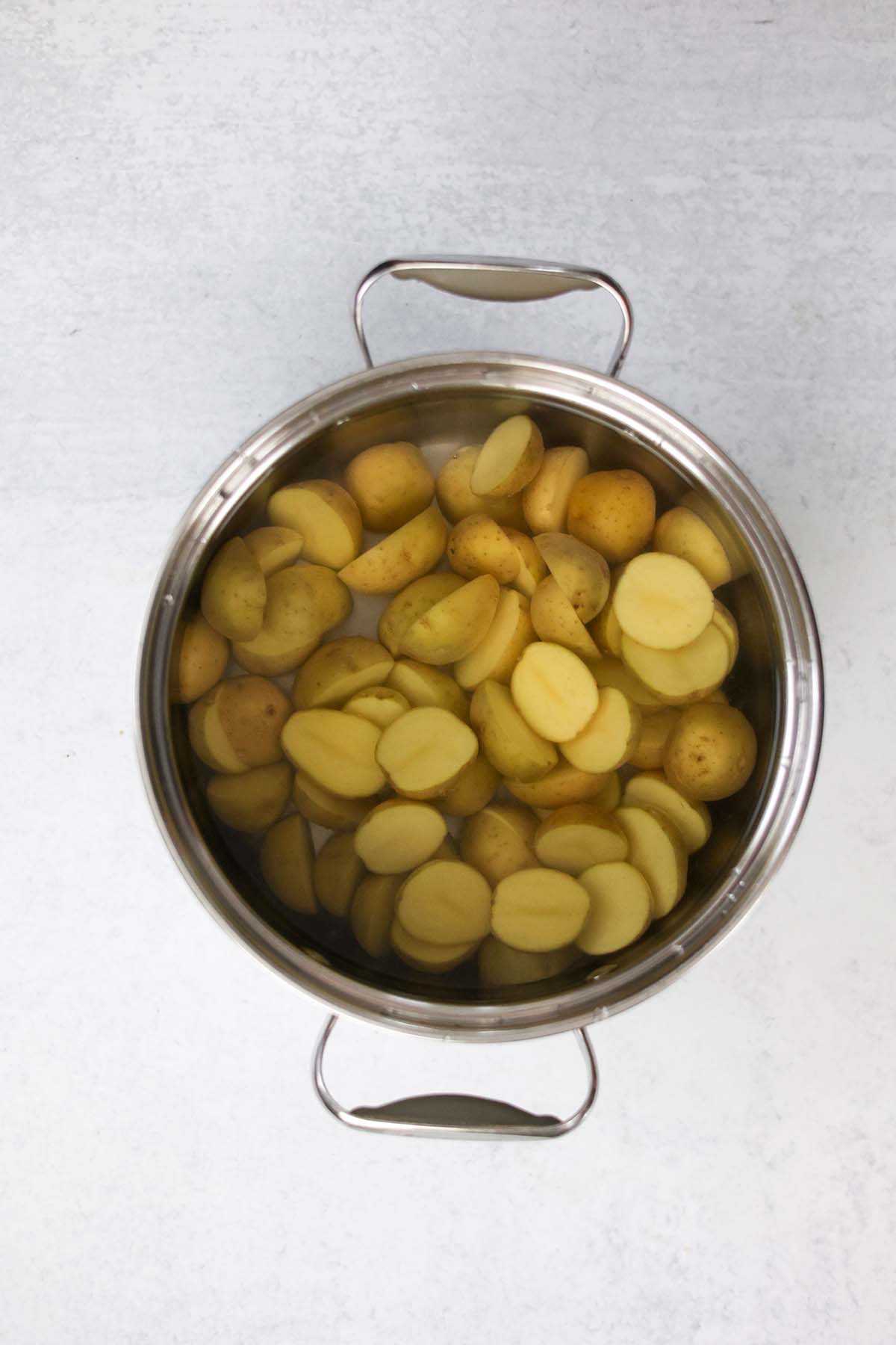 baby potatoes in a pot filled with water. 