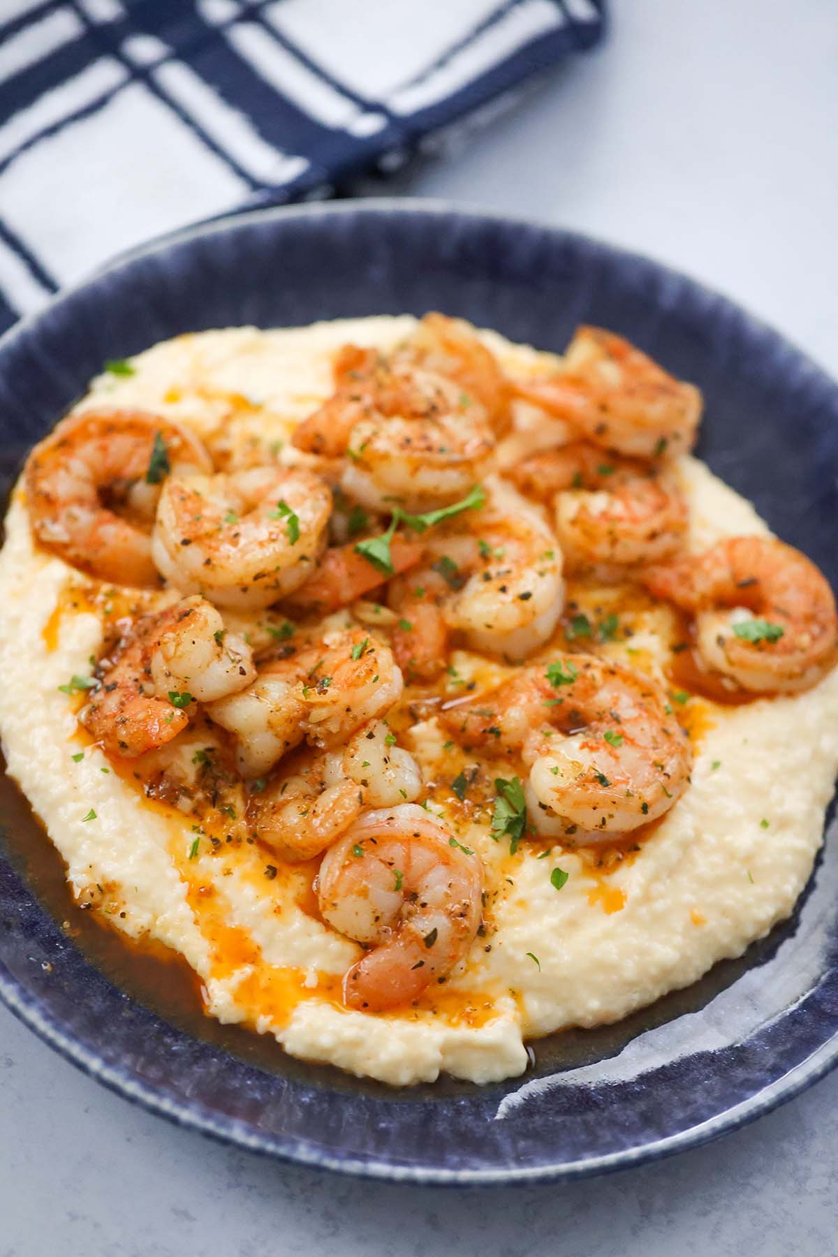 spicy shrimp and grits on a plate. 