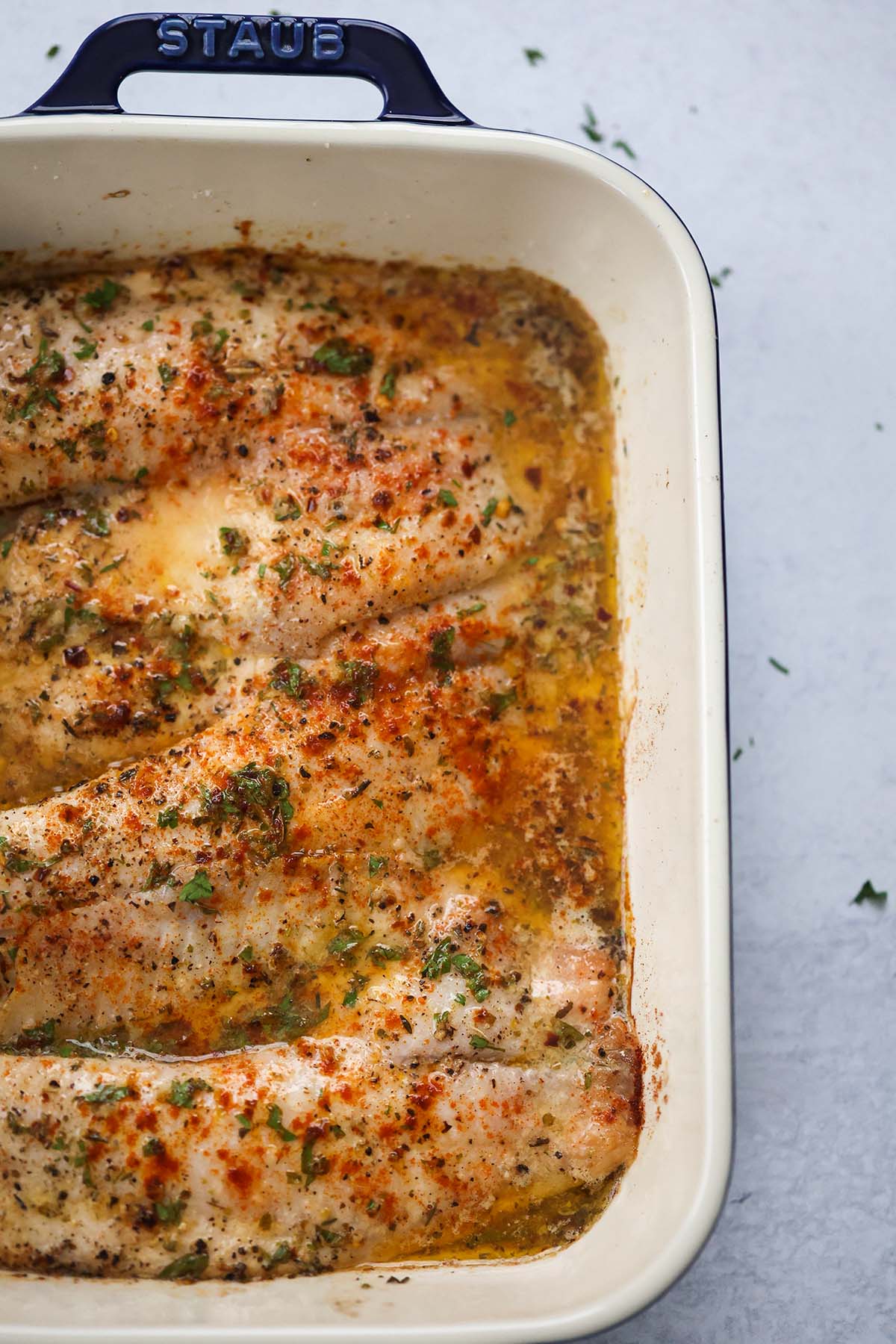 baked tilapia in a baking dish. 