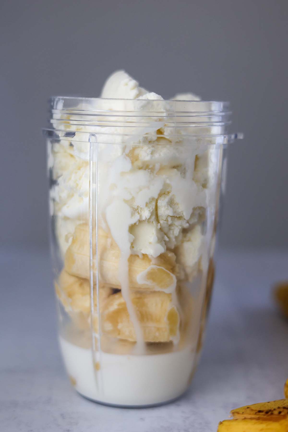 bananas, milk, and ice cream in a blender. 