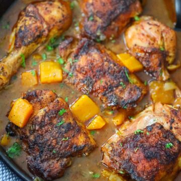 chicken with butternut squash stew in a pot.