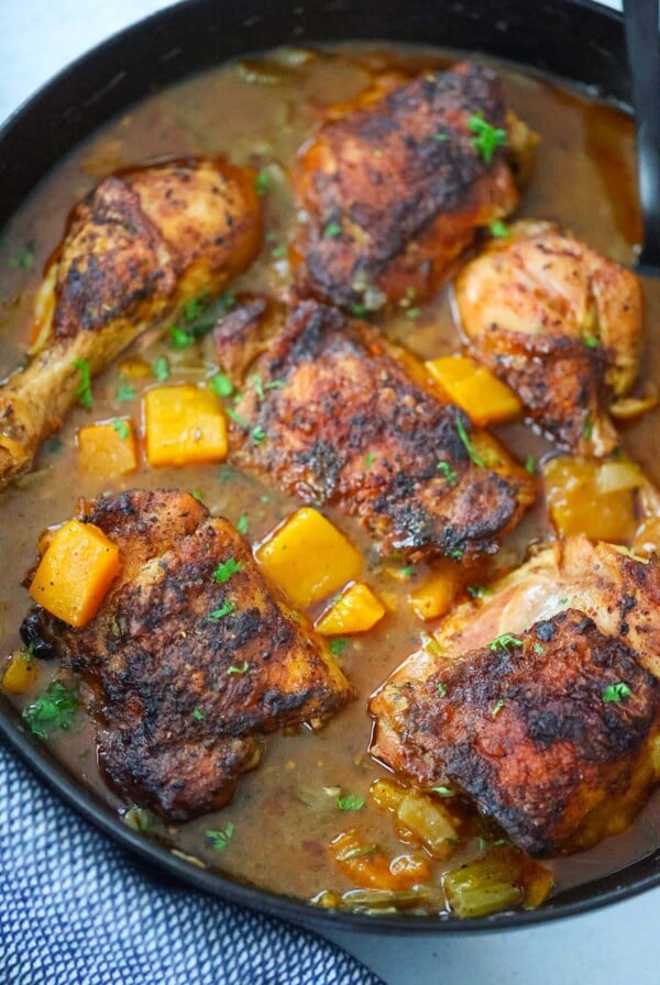 chicken with butternut squash stew in a pot.
