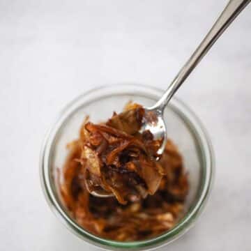 caramelized onions in a bowl with a spoon.