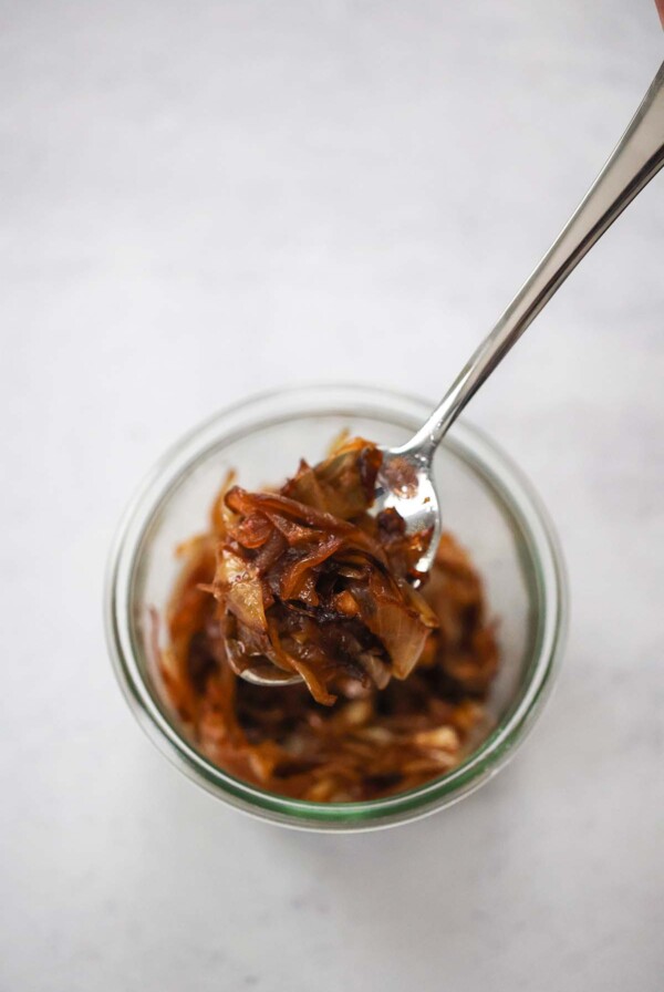 caramelized onions in a bowl with a spoon.