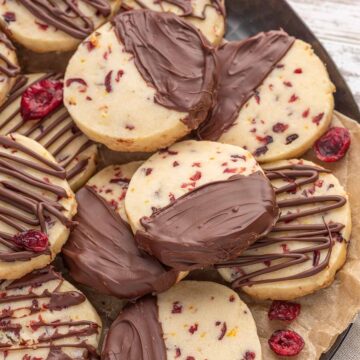 Chocolate cranberry orange shortbread cookies on a plate.