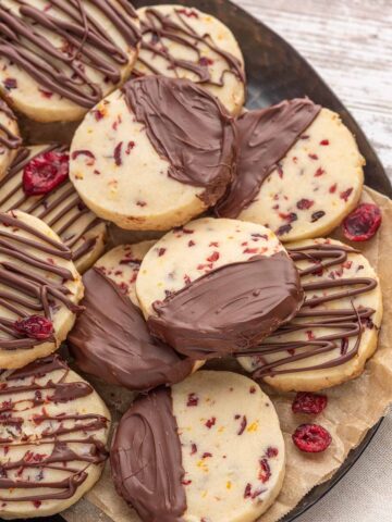 Chocolate cranberry orange shortbread cookies on a plate.