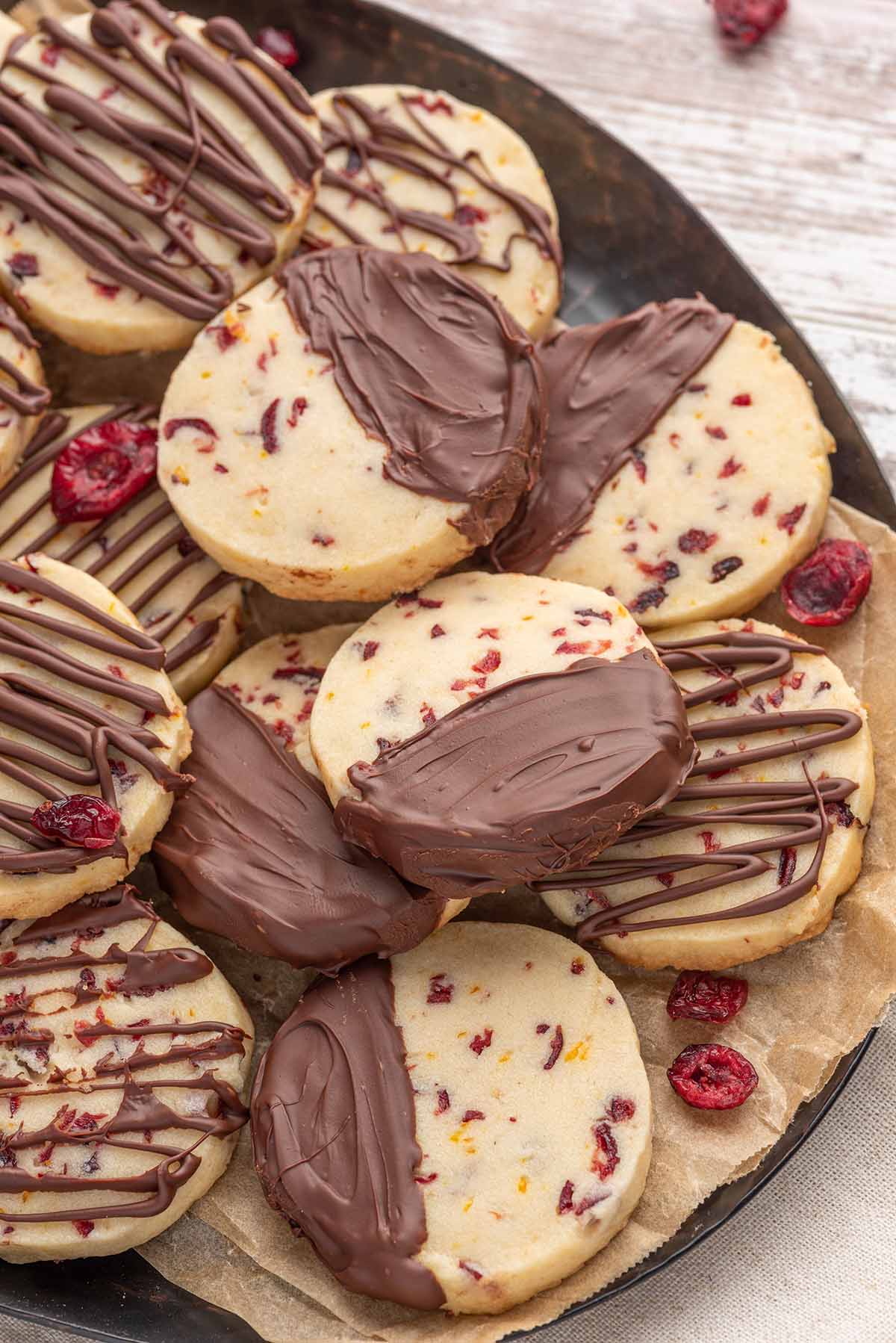Chocolate cranberry orange shortbread cookies on a plate. 