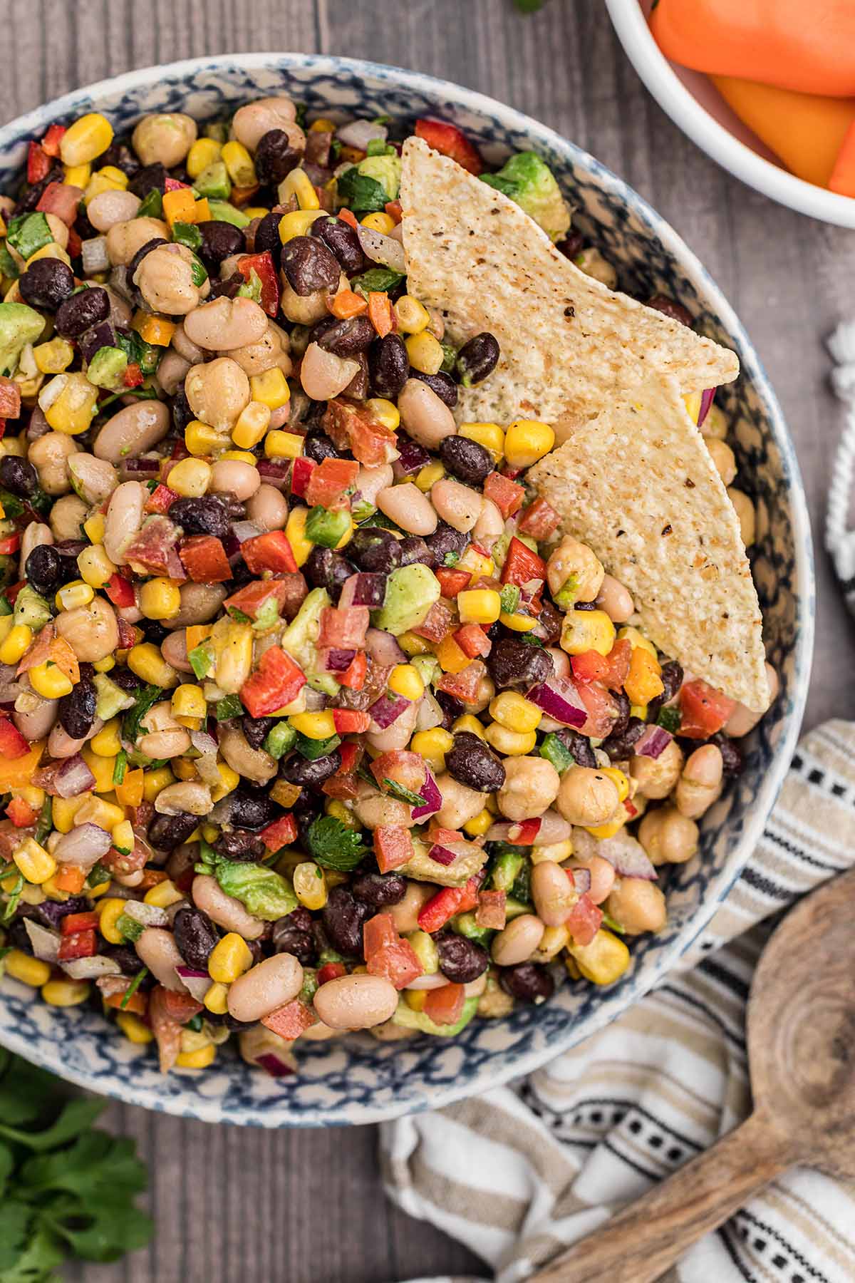 cowboy caviar in a bowl with two tortilla chips. 