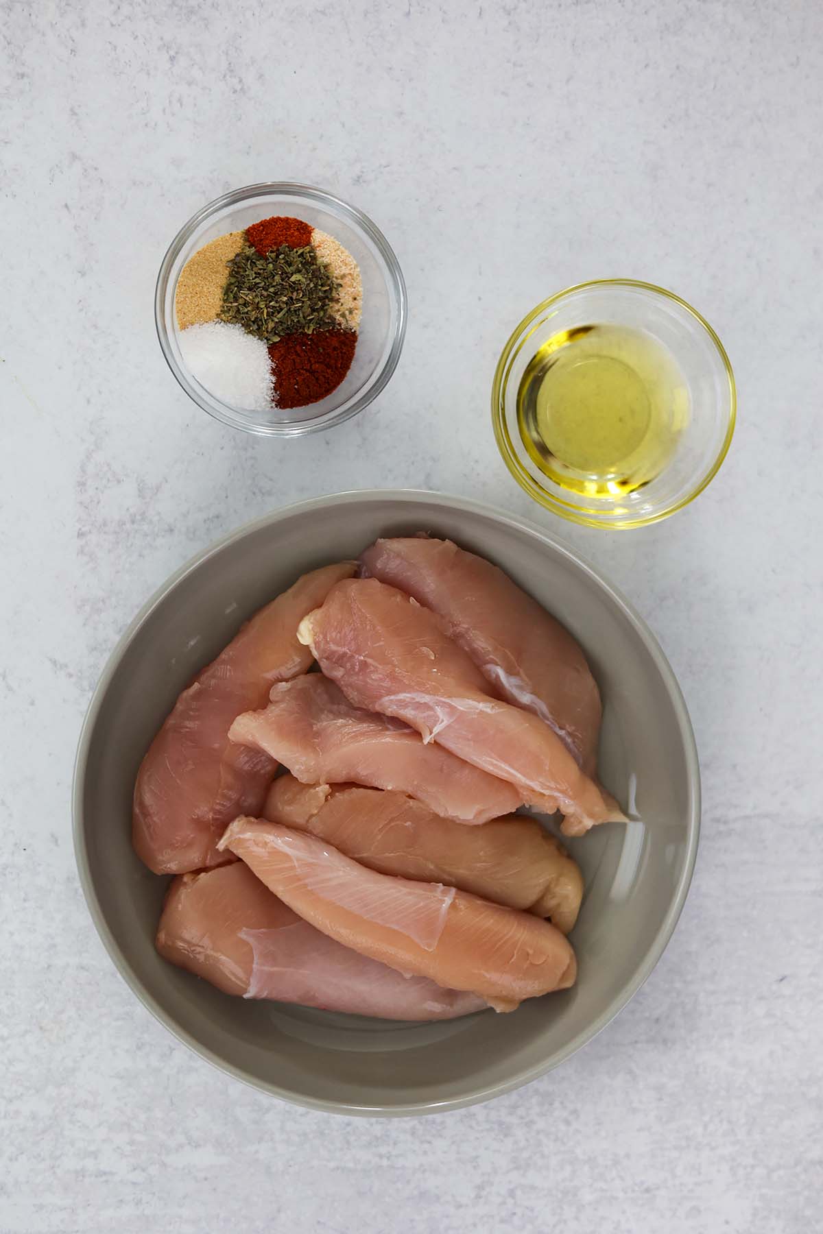 raw chicken tenderloins, olive oil, and spices. 