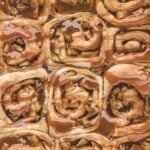 Twelve caramel apple cinnamon rolls up close.