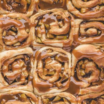 Twelve caramel apple cinnamon rolls up close.