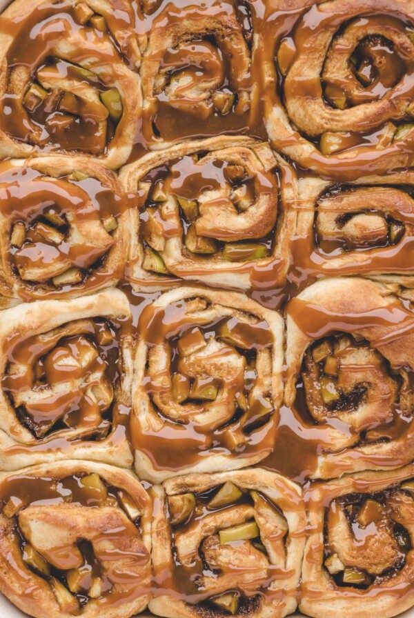 Twelve caramel apple cinnamon rolls up close.