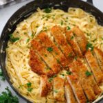 Crispy chicken sliced into bite sized pieces served over creamy Fettuccine Alfredo.