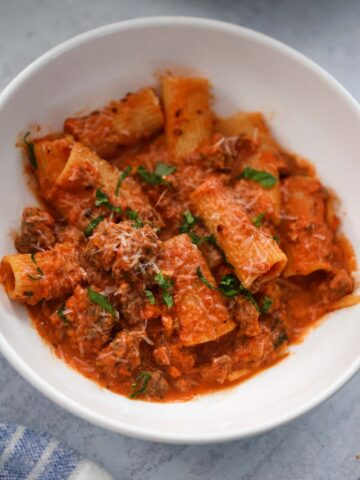 rigatoni with basil and parmesan cheese on top.