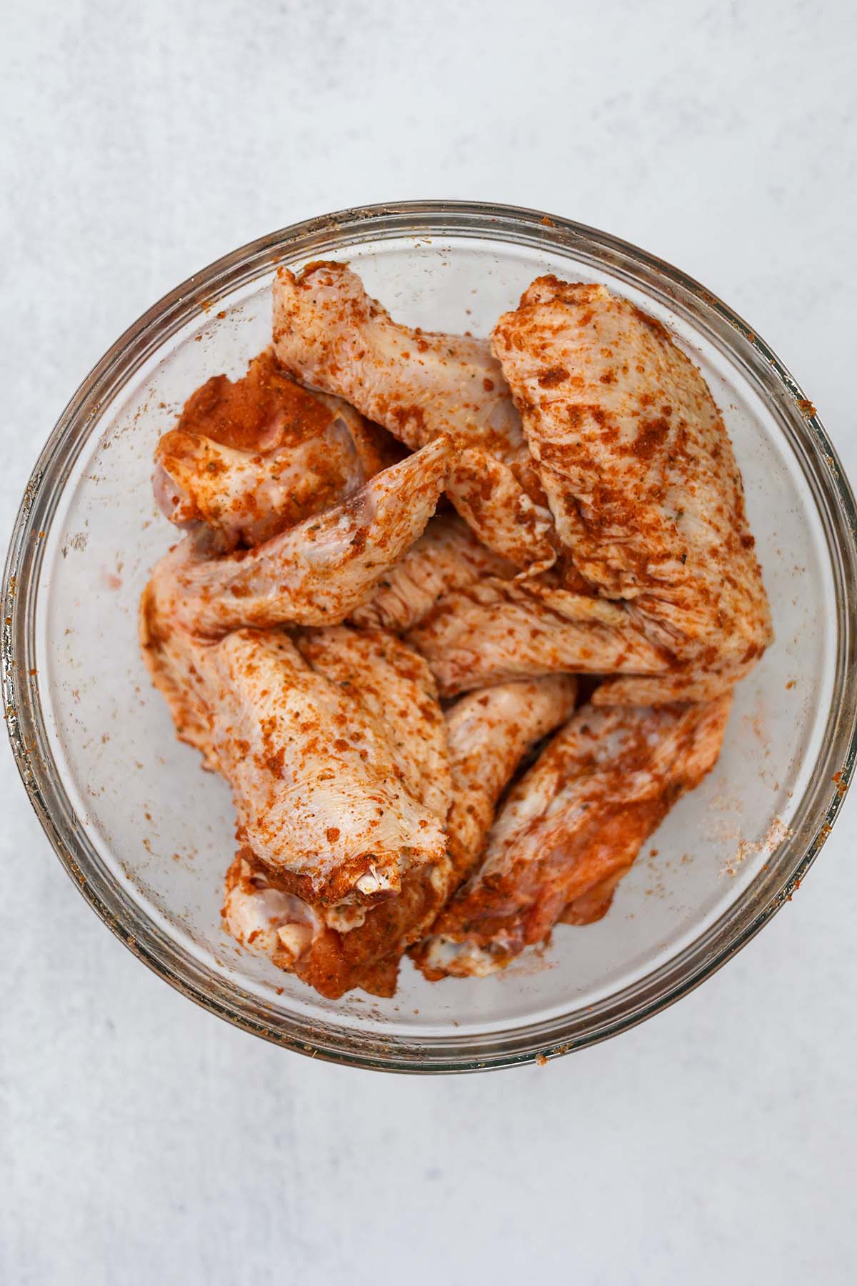 raw turkey wings coated in spices. 